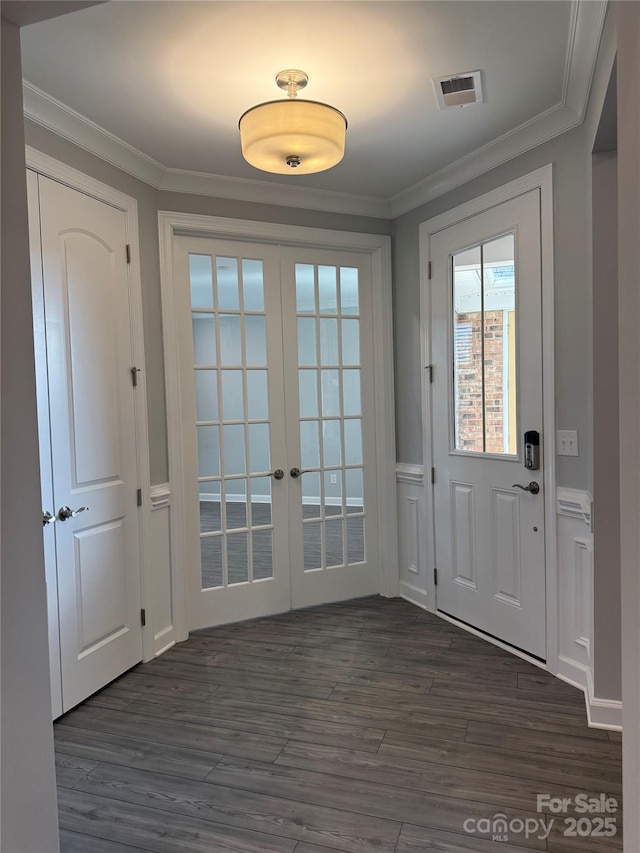 doorway to outside featuring dark hardwood / wood-style flooring, crown molding, and french doors