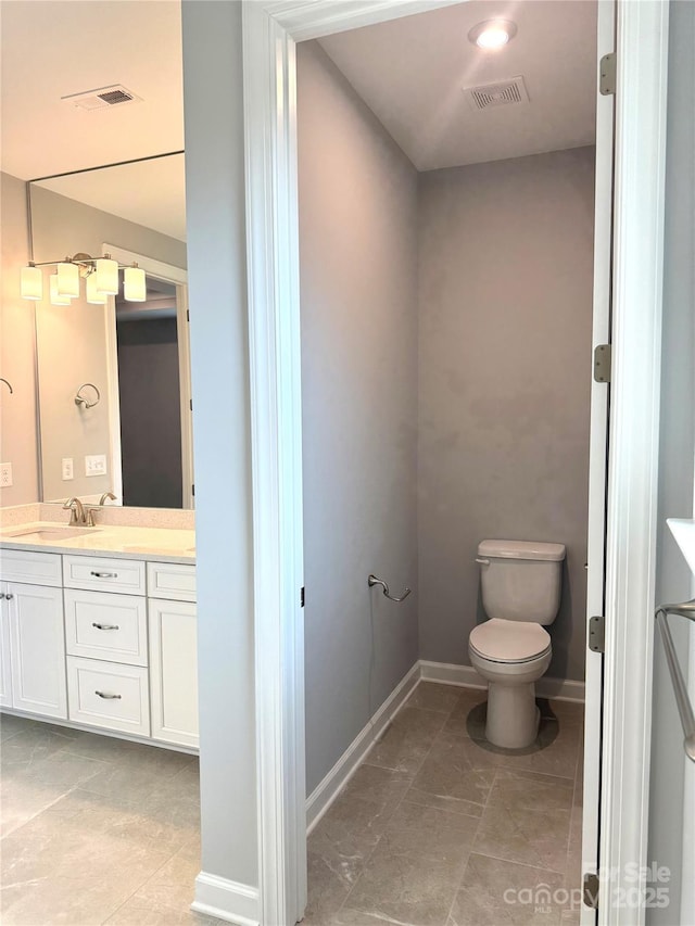 bathroom featuring toilet and vanity