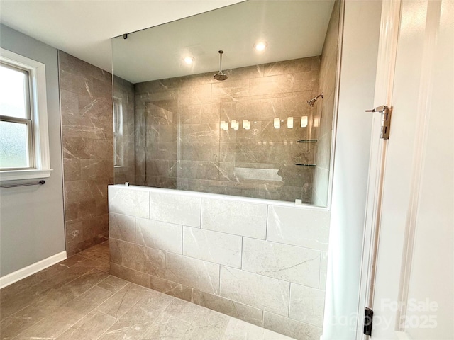 bathroom with tile patterned floors and tiled shower