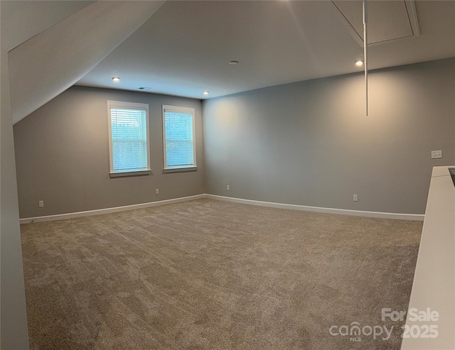 interior space with carpet and vaulted ceiling