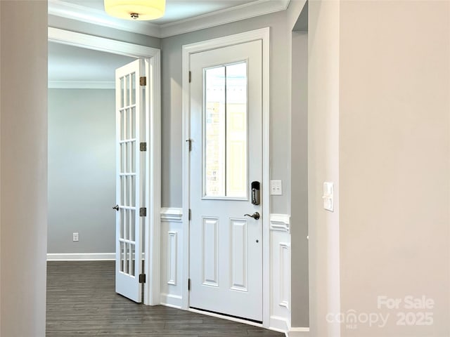 entrance foyer featuring baseboards, dark wood-type flooring, and ornamental molding