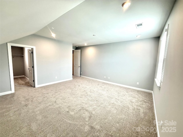 carpeted spare room featuring baseboards