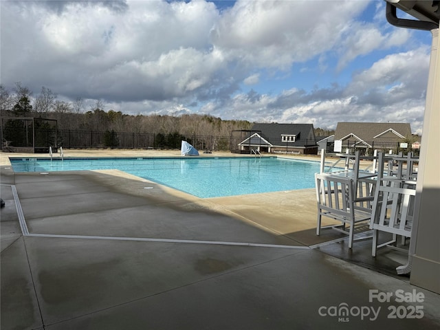 pool featuring a patio and fence