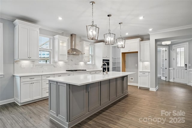 9657 Liberty Hill Dr, Mint Hill, NC 28227 - kitchen featuring wall chimney range hood, ornamental molding, stainless steel gas cooktop, light countertops, and white cabinetry