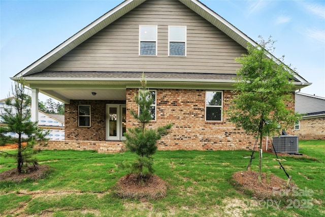 9657 Liberty Hill Dr, Mint Hill, NC 28227 - view of front facade with cooling unit, brick siding, a front lawn, and covered porch