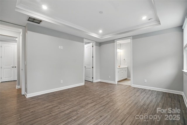 9657 Liberty Hill Dr, Mint Hill, NC 28227 - unfurnished bedroom with a raised ceiling, dark wood finished floors, baseboards, recessed lighting, and ensuite bath