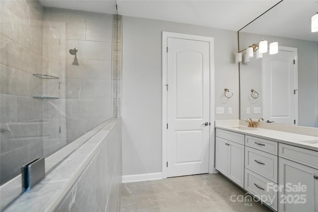 9657 Liberty Hill Dr, Mint Hill, NC 28227 - bathroom with double vanity, baseboards, marble finish floors, and a tile shower