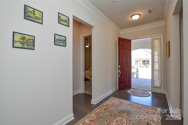 entryway featuring dark wood-type flooring and ornamental molding