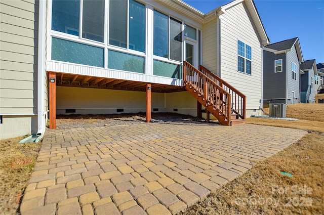 rear view of property with cooling unit and a patio