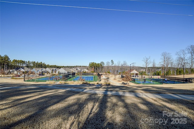 view of swimming pool featuring tennis court