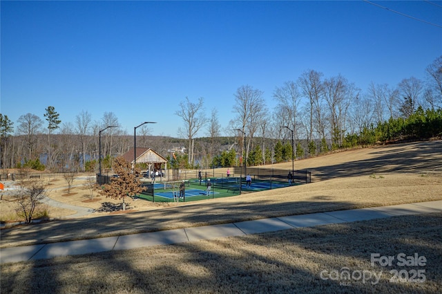 exterior space with tennis court and a gazebo