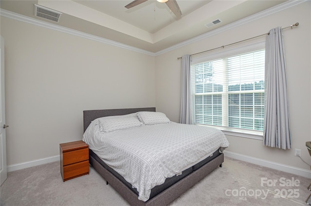 bedroom with ceiling fan, light colored carpet, and a raised ceiling