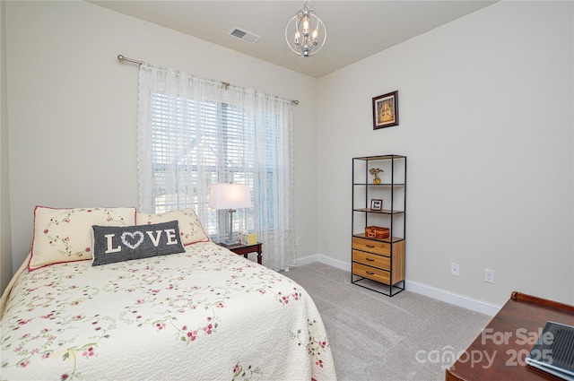 carpeted bedroom with an inviting chandelier