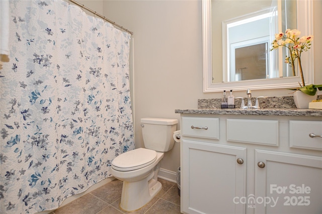 bathroom with toilet, tile patterned flooring, vanity, and curtained shower