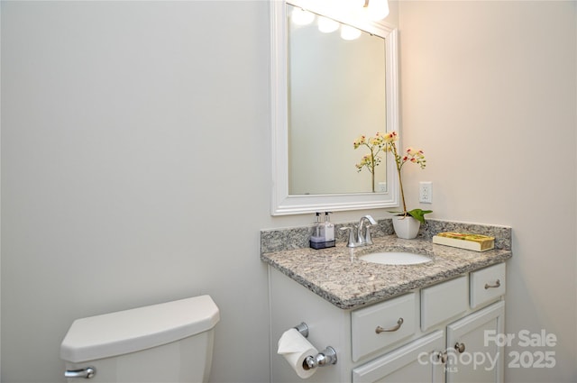 bathroom with toilet and vanity