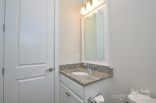 bathroom featuring toilet and vanity