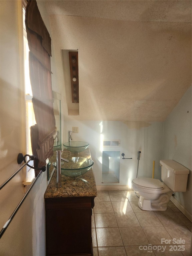 bathroom with vanity, tile patterned floors, and toilet