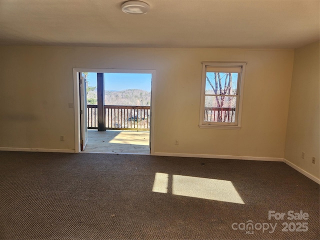 carpeted empty room featuring a mountain view