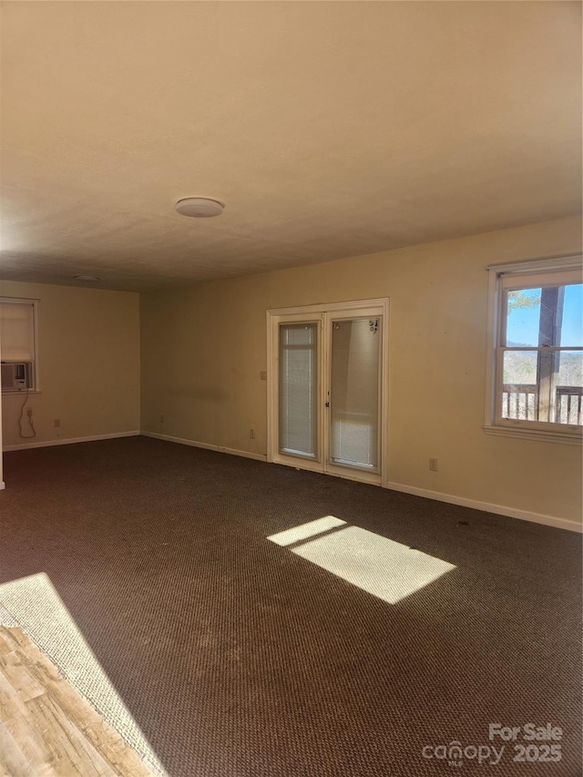 spare room featuring cooling unit and carpet floors