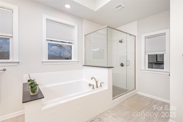 bathroom with separate shower and tub