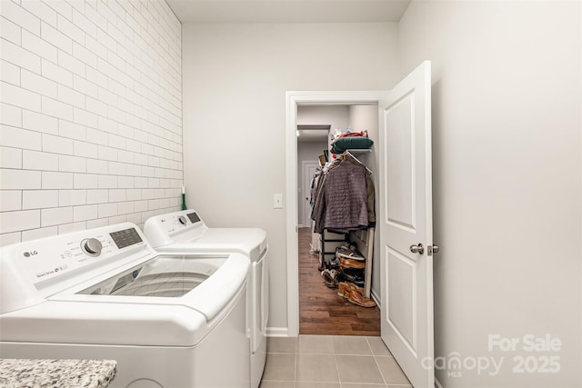 laundry room featuring light tile patterned floors and washer and dryer