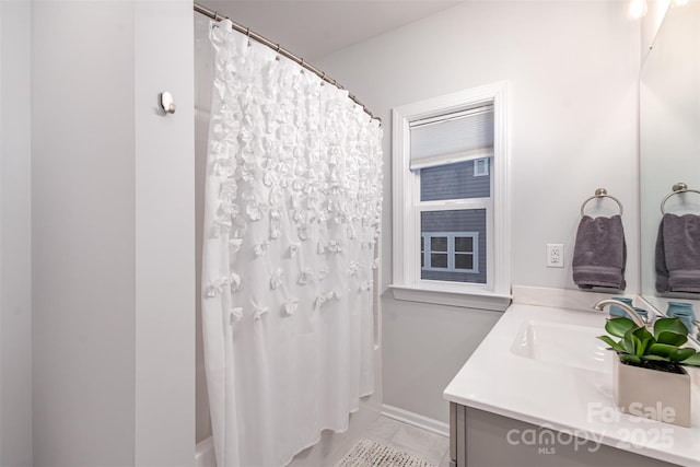 bathroom with tile patterned floors, vanity, and curtained shower