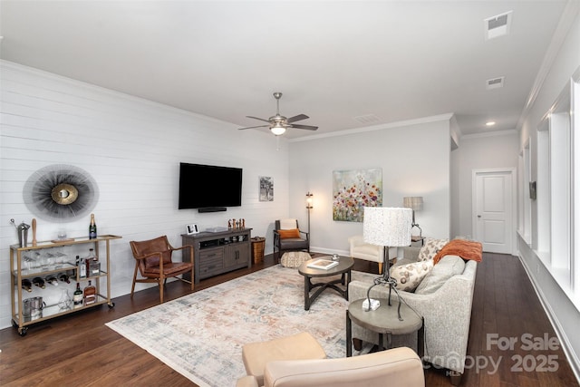 living room with ceiling fan, dark hardwood / wood-style floors, and crown molding