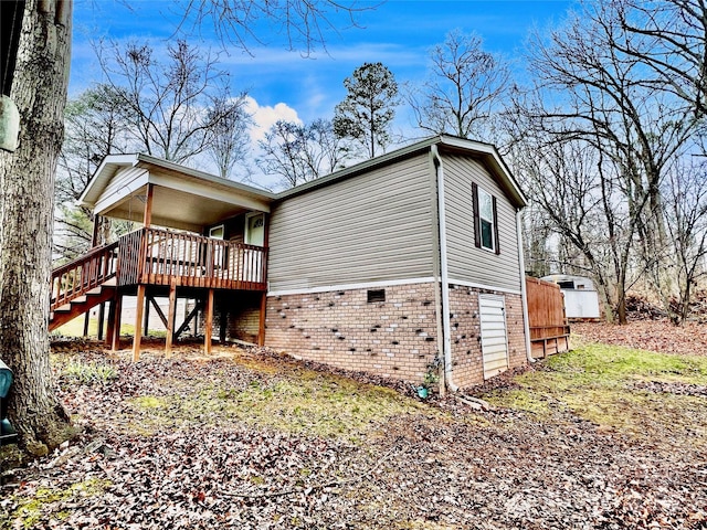 view of home's exterior featuring a wooden deck and a shed