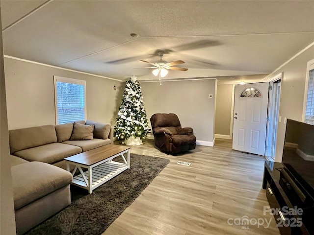 living room featuring ceiling fan, hardwood / wood-style floors, and ornamental molding