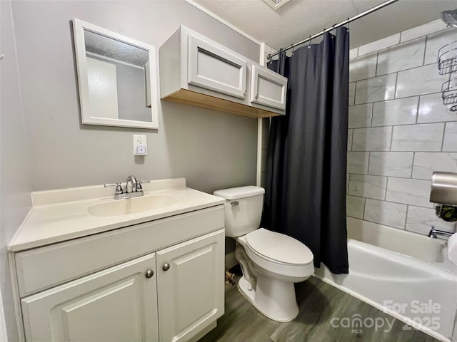 full bathroom with a textured ceiling, wood-type flooring, vanity, shower / bath combination with curtain, and toilet