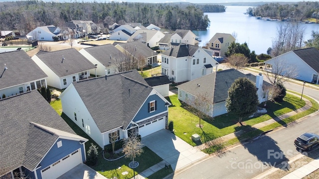 birds eye view of property with a water view