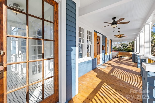 deck with covered porch and ceiling fan