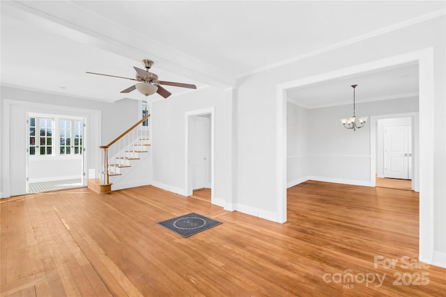 unfurnished living room with crown molding, ceiling fan with notable chandelier, and hardwood / wood-style floors