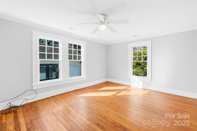 unfurnished room featuring ceiling fan, wood-type flooring, and ornamental molding