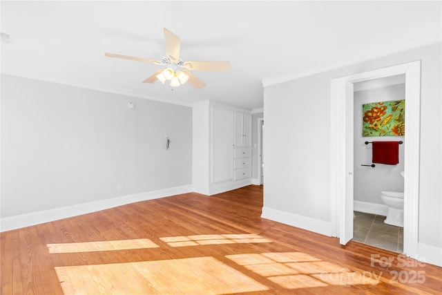 empty room with ceiling fan, ornamental molding, and hardwood / wood-style floors