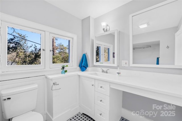 bathroom featuring toilet and vanity