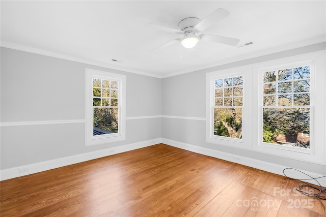 empty room featuring ceiling fan, ornamental molding, and hardwood / wood-style floors