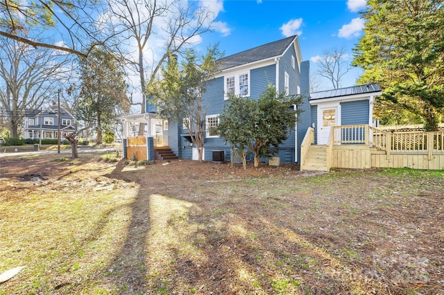 rear view of property with cooling unit