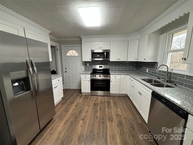 kitchen with white cabinets, stainless steel appliances, light stone countertops, and sink