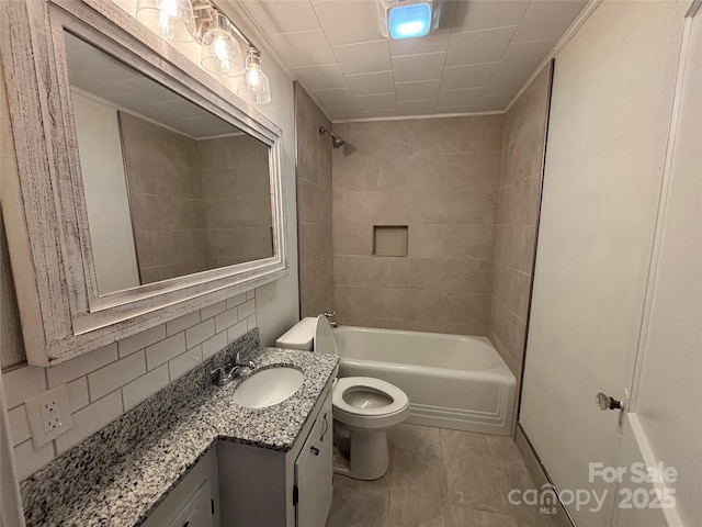 full bathroom featuring vanity, tiled shower / bath, toilet, and backsplash