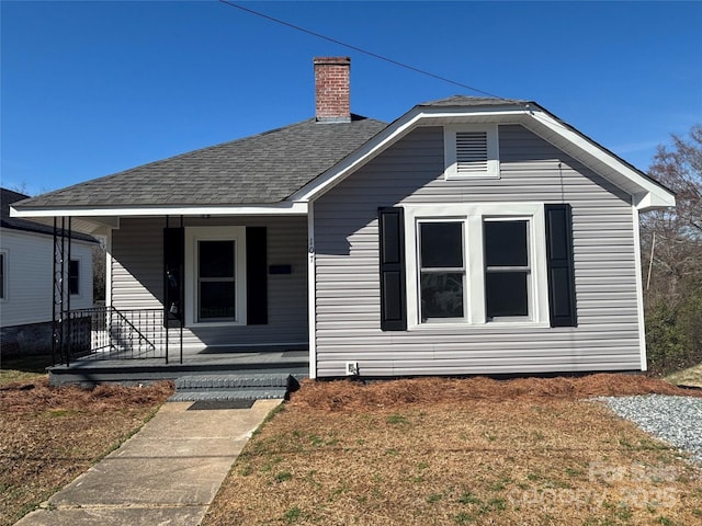 bungalow-style house with covered porch and a front lawn