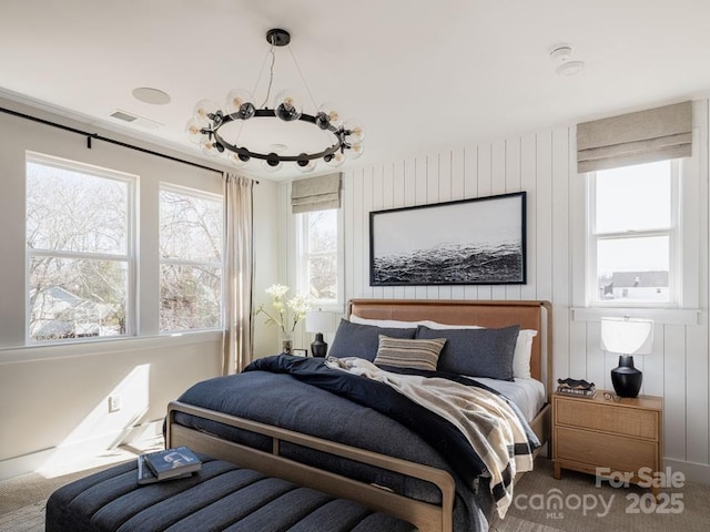 bedroom with carpet and a chandelier