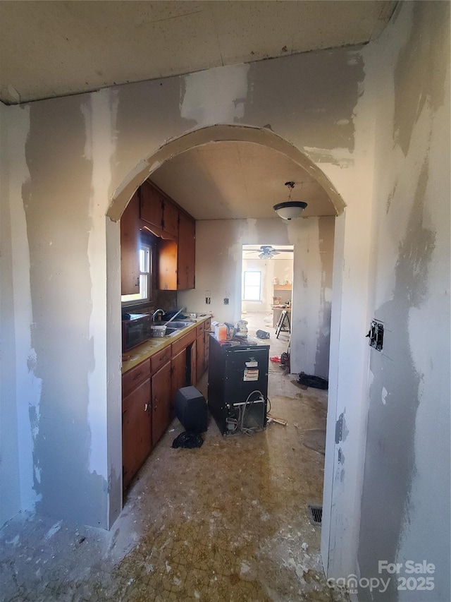 kitchen featuring ceiling fan and sink