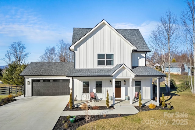 modern farmhouse with a front lawn, covered porch, and a garage