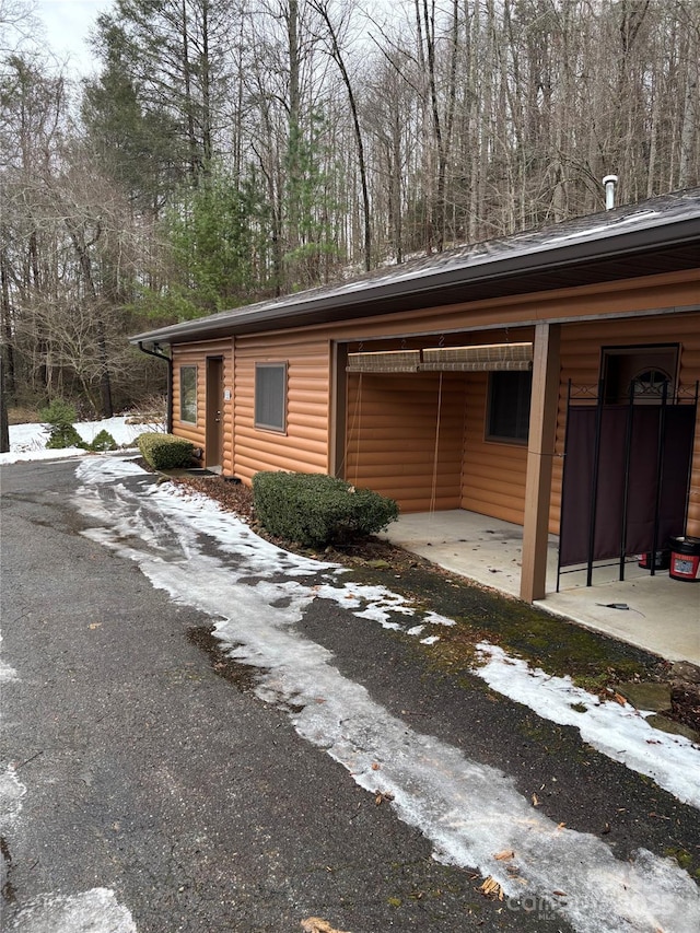 view of side of property with a carport