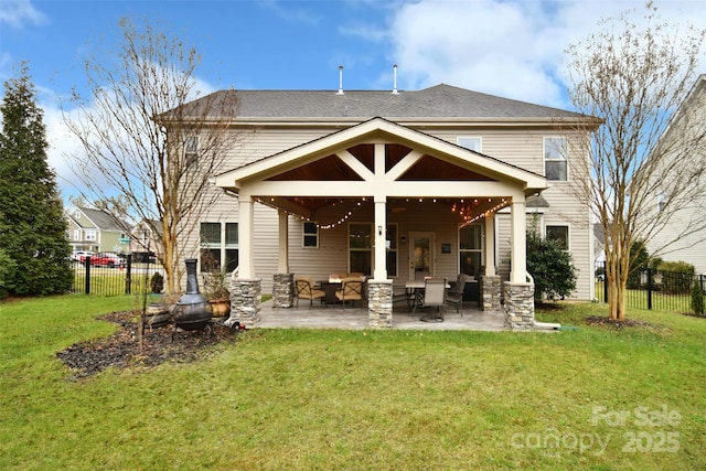 rear view of house featuring a patio and a yard