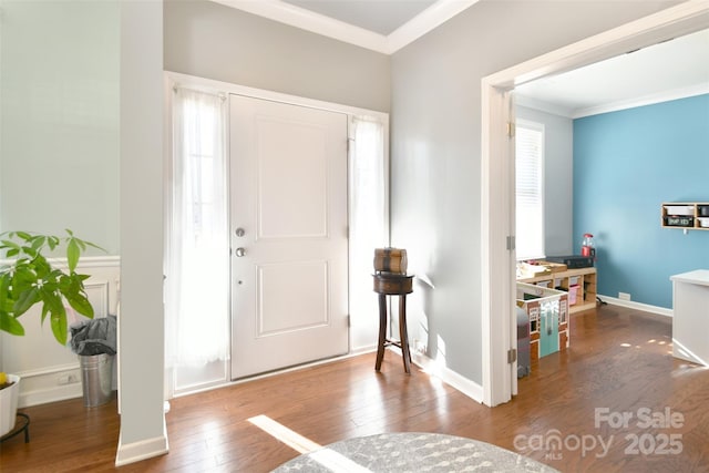 entryway with ornamental molding and wood-type flooring