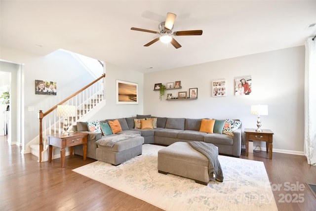 living room with ceiling fan and dark hardwood / wood-style flooring