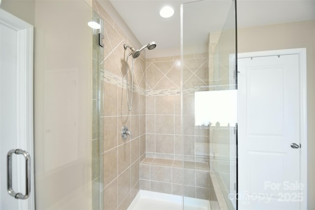 bathroom featuring a shower with door