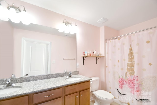 bathroom featuring vanity, a shower with shower curtain, and toilet